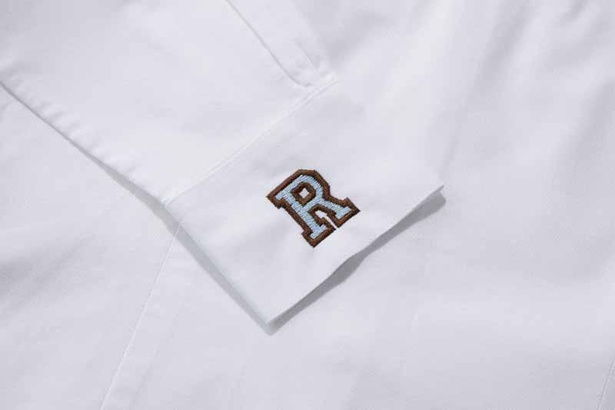 白地のシャツに水色で「R」を刺繍し、爽やかなイメージに