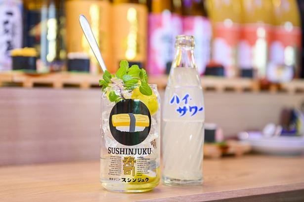玉子寿司のイラストや店名が書かれたオリジナルのグラスは、形もデザインもビールの缶をイメージしている