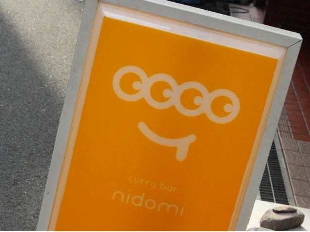 店舗は雑居ビルの2階。入口の階段前にあるオレンジ色の「ニドミ」看板が目印！