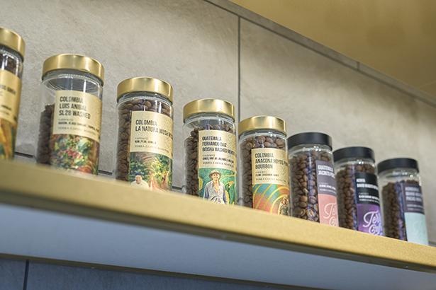 ラベルのデザインも多彩なボトルで豆を販売。金色のラベルは各国の品評会入賞豆