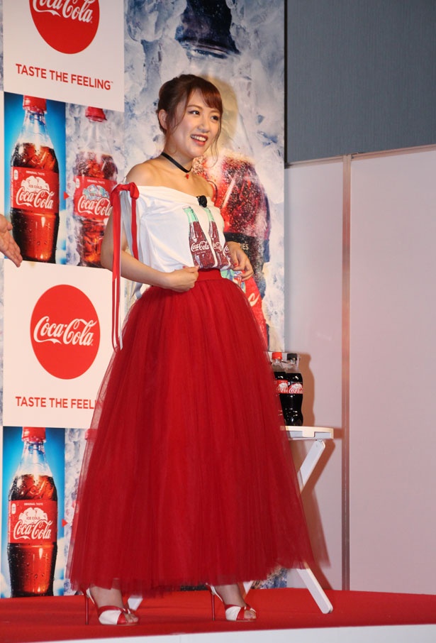 【写真を見る】大胆に肩を露出したセクシーな「コカ・コーラ」柄のTシャツと、真っ赤なスカートに衣装チェンジした高橋