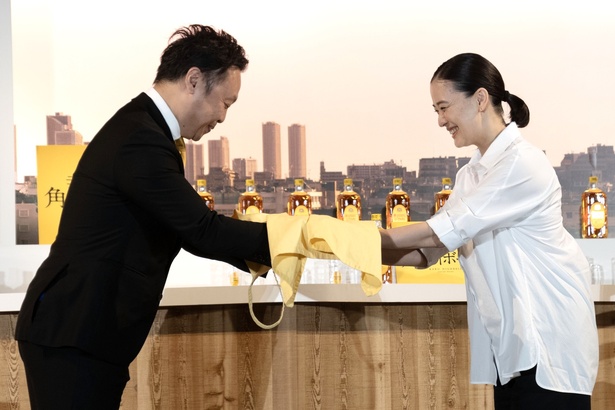 新店主就任セレモニーで、黄色いエプロンを贈呈される蒼井優