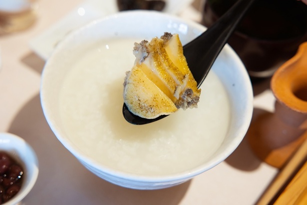 優しい味わいのかゆに、アワビをのせ、アワビを煮た一番ダシで作る秘伝のたれをかけて味わう