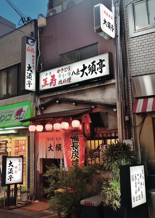 巨大赤ちょうちんとダクトから出る焼鳥の香りが、道行く人を誘惑する / 大須亭