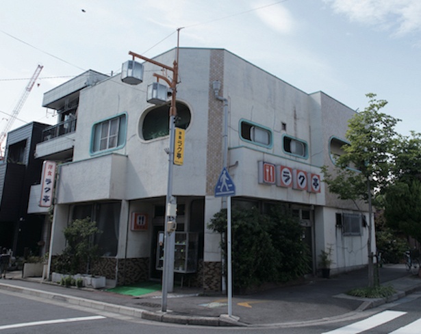 フォークとナイフが描かれたオレンジ色の看板が目印。店の前には行列ができることも / ラク亭