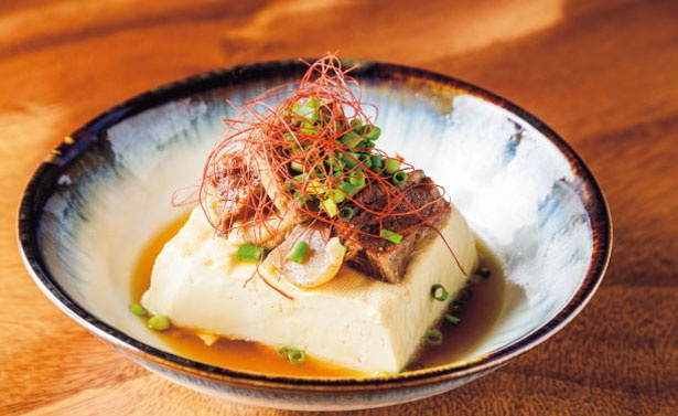 【写真を見る】どて肉豆腐(594円)はおでんの豆腐(木綿)に、味噌ベースでピリ辛に煮た牛スジがのる/スタンドアタリ