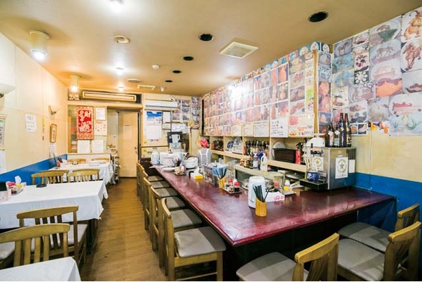 中国料理 徳福 / 店内には、カウンターもあり。店主が得意とする食品彫刻の写真が多数飾られている