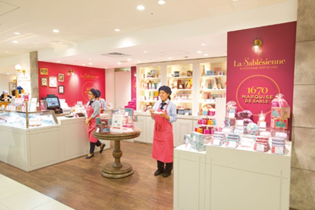 フランスの本店をイメージさせるような華やかな雰囲気の売場はピンク色の壁がかわいい。ずらっと並ぶさまざまなサブレ缶にも目をひかれる/ラ・サブレジエンヌ