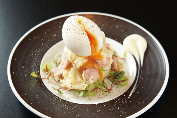 糸島豚ソーセージのポテトサラダ(580円)。半熟卵と一緒に食べればまろやかさアップ / 黄金のニク酒場 しん・ぜんび