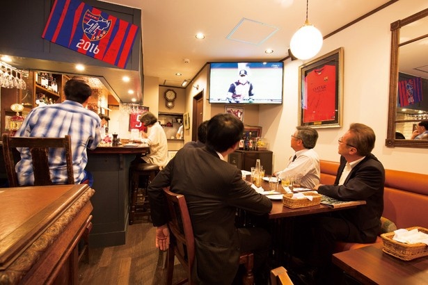 「Restaurant ＆ Bar R」の店内には、50インチと60インチのテレビを2台設置。壁にはFC東京の選手のサインなども展示されている