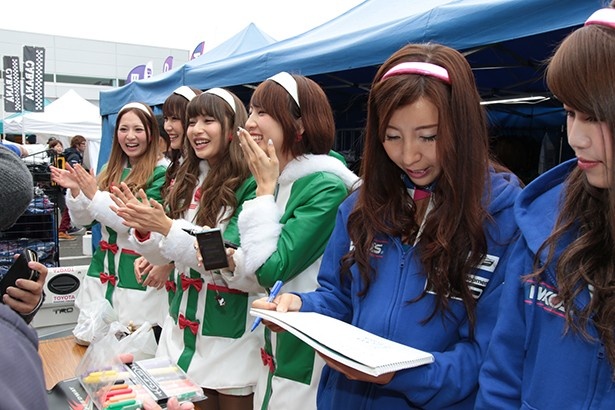 ファンからのサインに応えるレースクイーン達